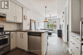 Grimsby (Grimsby Beach) townhouse for rent - A modern kitchen with white cabinets and stainless steel appliances.