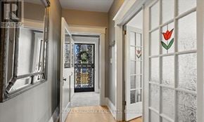 Toronto (Birchcliffe-Cliffside) apartment for rent - A hallway with a black door and a tulip sticker on the white door.