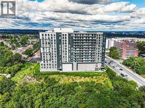 Stoney Creek apartment for rent - A large building with a green lawn in front of it.