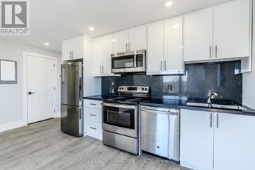 Bradford West Gwillimbury (Bradford) multi-family for rent - A modern kitchen with white cabinets and stainless steel appliances.