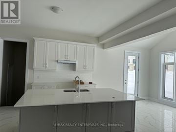 Oro-Medonte apartment for rent - A kitchen with white cabinets and a marble countertop.