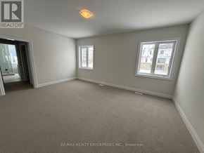Oro-Medonte apartment for rent - A room with a carpeted floor and two windows.