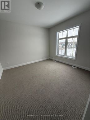 Oro-Medonte apartment for rent - A room with a carpeted floor and a window showing a snowy landscape outside.