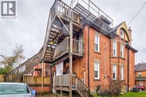 Hamilton apartment for rent - A house with a wooden deck and a balcony.