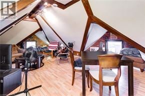 Hamilton apartment for rent - A room with wooden floors and furniture, a television, and a camera on a tripod.