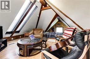 Hamilton apartment for rent - A room with a guitar on a chair and a laptop on a table.