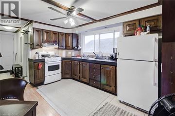 Hamilton apartment for rent - A kitchen with wooden cabinets and a white fridge.