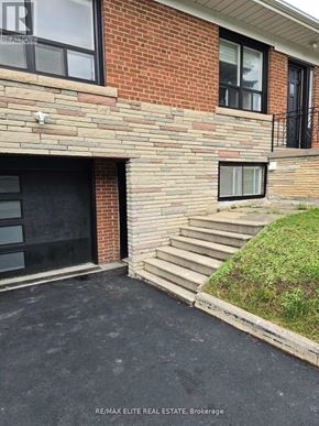 Toronto (Newtonbrook East) apartment for rent - A brick house with a black window and a small window with a black frame.
