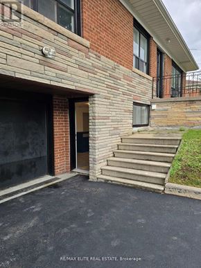 Toronto (Newtonbrook East) apartment for rent - A brick house with a black door and steps leading up to it.