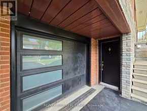 Toronto (Newtonbrook East) apartment for rent - A black door with a glass window is on the left side of a brick wall.