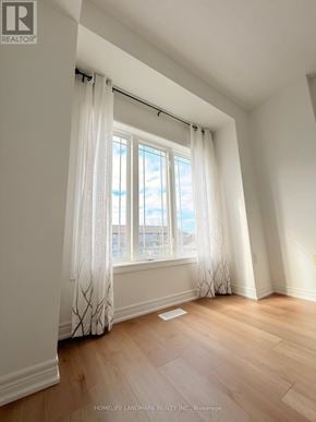 Hamilton townhouse for rent - A room with a window and curtains.