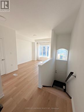 Hamilton townhouse for rent - A room with wooden floors and white walls.