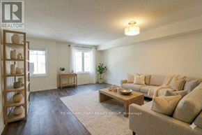 Ottawa townhouse for rent - A living room with a couch, a coffee table, and a plant.
