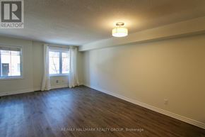 Ottawa townhouse for rent - A room with a window and a wooden floor.