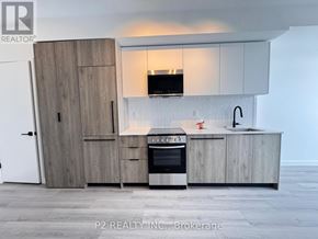 Toronto (Centennial Scarborough) condo for rent - A modern kitchen with a wooden cabinet and a built-in oven.