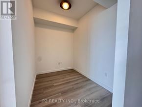 Toronto (Centennial Scarborough) condo for rent - A room with wooden flooring and white walls, with a light on the ceiling.