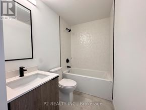 Toronto (Centennial Scarborough) condo for rent - A bathroom with a toilet, sink, and bathtub.