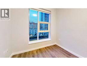 Vancouver apartment for rent - A room with a window showing a view of a building.