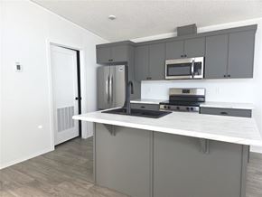 Mitchell apartment for rent - A kitchen with a white countertop and grey cabinets.