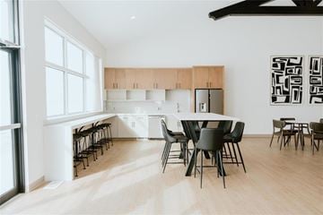 Mitchell apartment for rent - A modern dining room with a white table and black chairs.