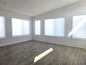 Mitchell apartment for rent - A room with wooden flooring and three windows.