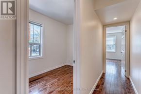 Toronto (New Toronto) apartment for rent - A room with wooden floors and white walls, with a window and a door visible.