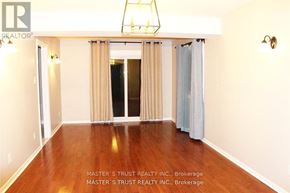 Oakville (Fd Ford) apartment for rent - A room with a wooden floor and a large window with curtains.