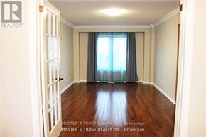 Oakville (Fd Ford) apartment for rent - A room with wooden floors and a window with curtains.