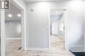 Ottawa townhouse for rent - A hallway with white walls and a black doormat.