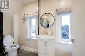 Ottawa townhouse for rent - A white toilet sits next to a sink in a small bathroom.