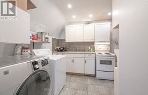 Ottawa townhouse for rent - A kitchen with white appliances and cabinets.