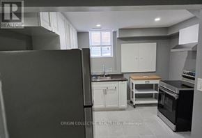 Clarington (Courtice) apartment for rent - A kitchen with a refrigerator, oven, and cabinets.