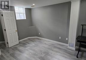 Clarington (Courtice) apartment for rent - A room with a white door and a window with a grey wall.