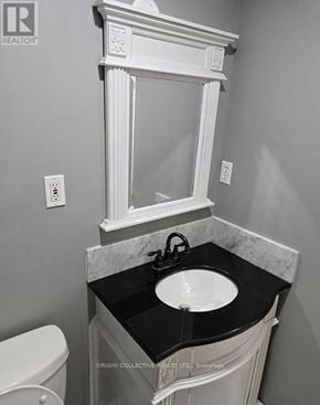 Clarington (Courtice) apartment for rent - A bathroom with a white framed mirror above a sink.