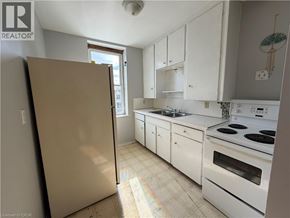 Watford apartment for rent - A kitchen with white cabinets and appliances is shown.