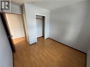 Watford apartment for rent - A room with wooden flooring and a white door.