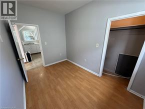 Watford apartment for rent - A room with wooden flooring and a fireplace.