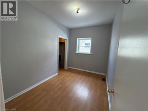 Watford apartment for rent - A room with wooden flooring and a window.