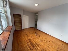 Watford apartment for rent - A room with wooden flooring and white walls.