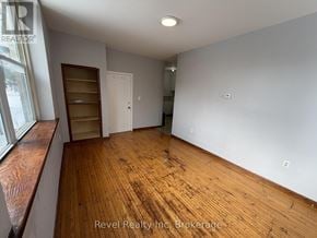 Warwick (Watford) fourplex for rent - A room with wooden floors and white walls, with a window on the left side.