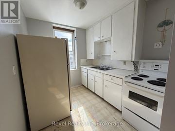 Warwick (Watford) fourplex for rent - A kitchen with white cabinets and appliances.