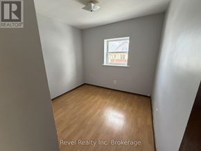 Warwick (Watford) fourplex for rent - A room with a window and wooden flooring.