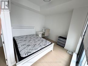 Toronto (Church-Yonge Corridor) condo for rent - A bedroom with a bed, nightstand, and a window.