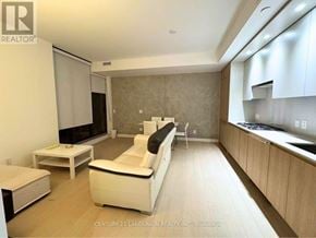 Toronto (Church-Yonge Corridor) condo for rent - A living room with a white couch and a television.