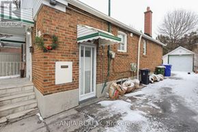 Toronto (East York) apartment for rent - A red brick house with a green roof and a white door.