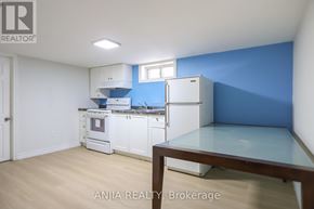 Toronto (East York) apartment for rent - A kitchen with white appliances and a blue wall.