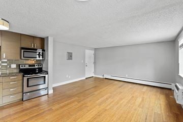 Denver apartment for rent - A kitchen with a stove top oven and microwave.