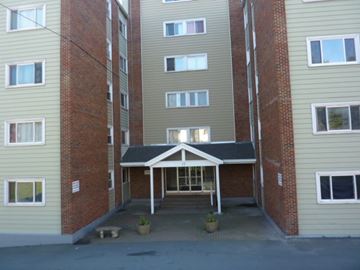 Halifax apartment for rent - A building with a covered walkway between two sections.