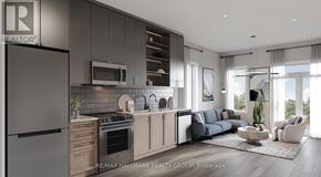 Ottawa apartment for rent - A modern kitchen with a refrigerator on the left and a living room with a couch and a coffee table on the right.