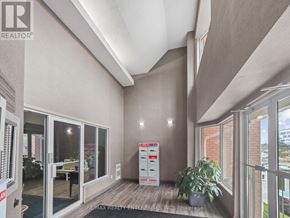 Barrie (Alliance) condo for rent - A room with a white cabinet and a plant in it.